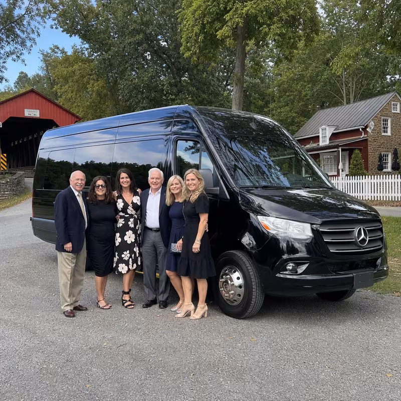 Group beside a Mercedes Sprinter limo from the Lancaster fleet
