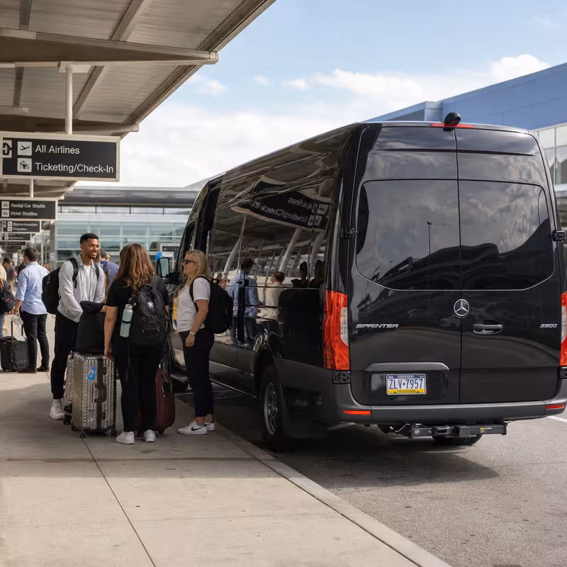 Group boarding a white charter bus for Airport Transportation transportation in Lancaster