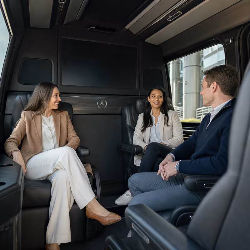 Group boarding a white charter bus for Corporate Transportation transportation in Lancaster