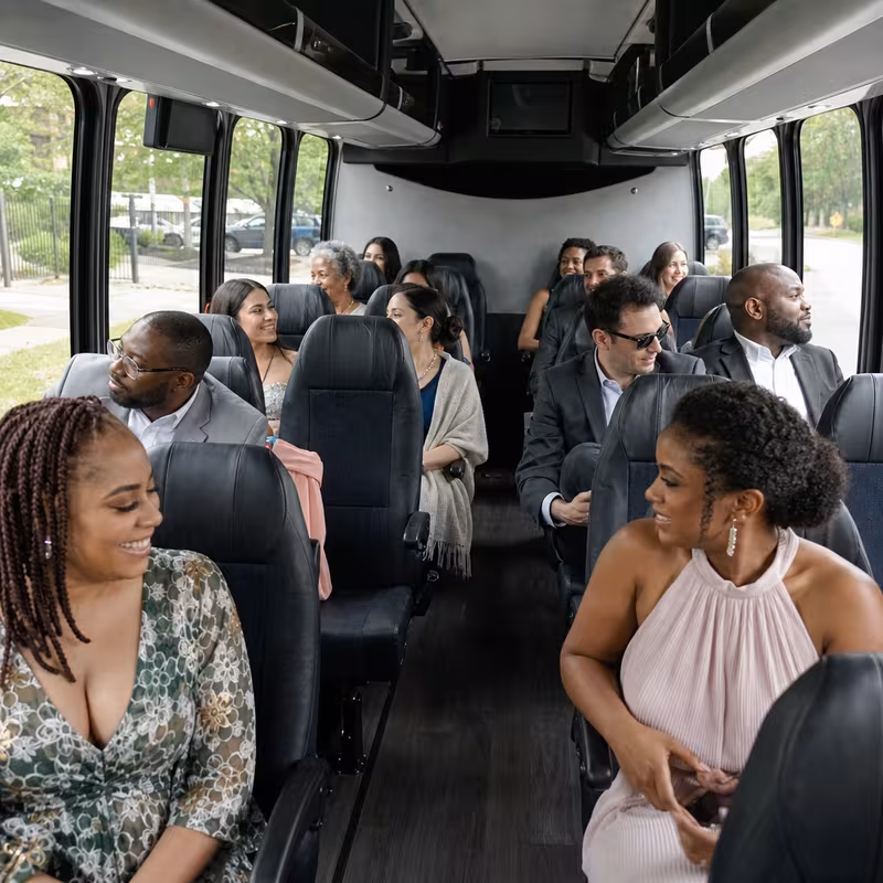 Group boarding a white charter bus for Private Event Transportation transportation in Lancaster