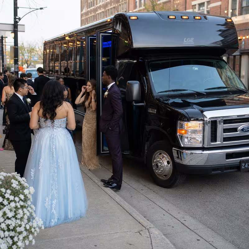 Passengers loading luggage while boarding an Lancaster group shuttle