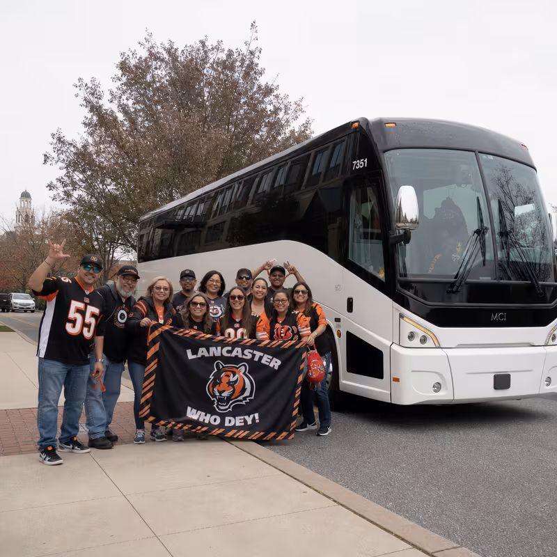 Passengers loading luggage while boarding an Lancaster group shuttle