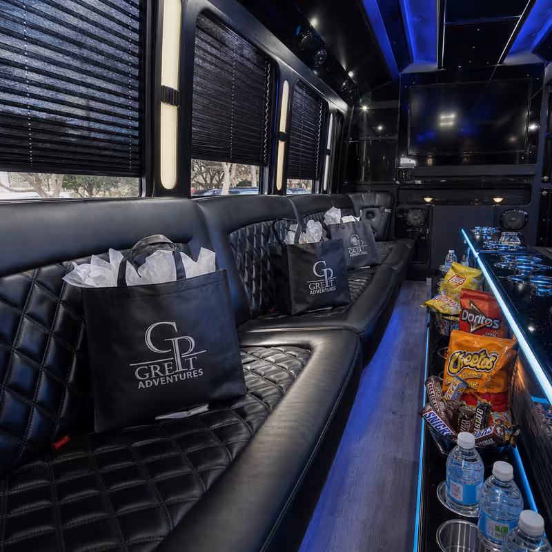 Party bus interior with wraparound leather seating and LED lighting in Lancaster